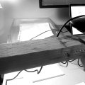 photo of my desk with a webcam on an improvised wooden arm, pointing down at paper. The drawing is seen on the computer monitor as well.